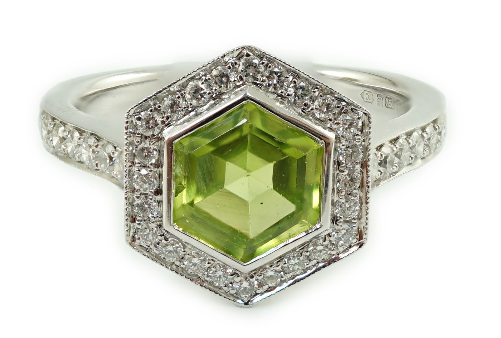 A modern 18ct white gold, peridot and diamond set hexagonal cluster set dress ring